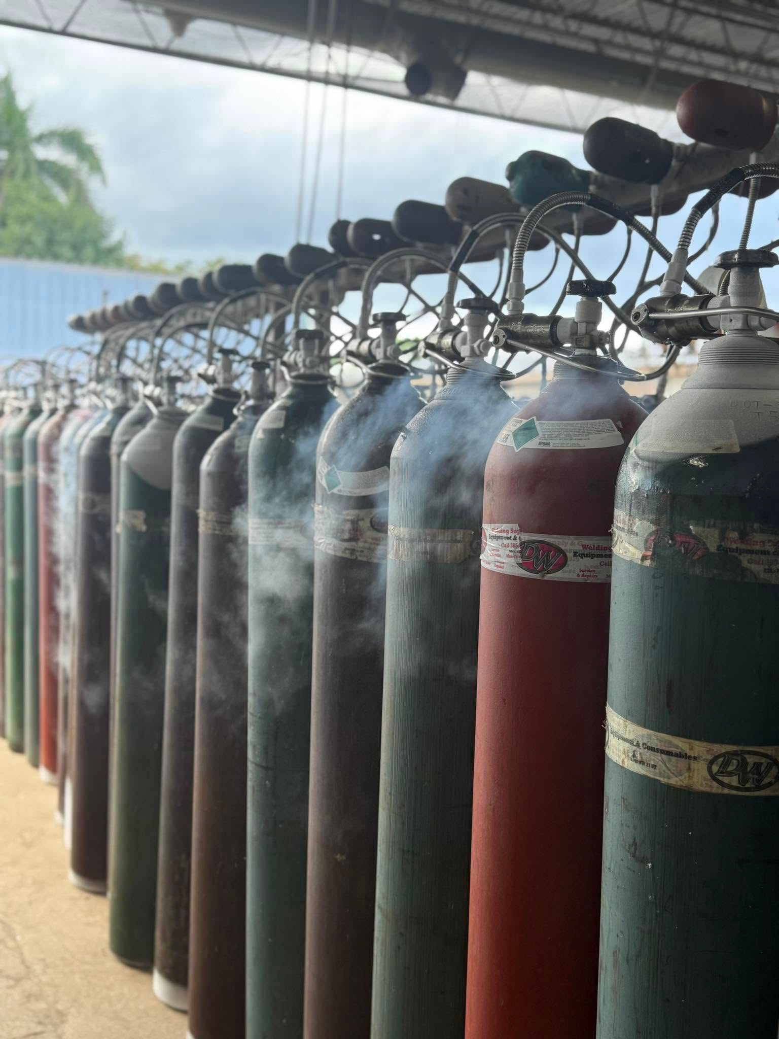 Gas cylinders connected to a filling manifold at Lake Welding Supplies